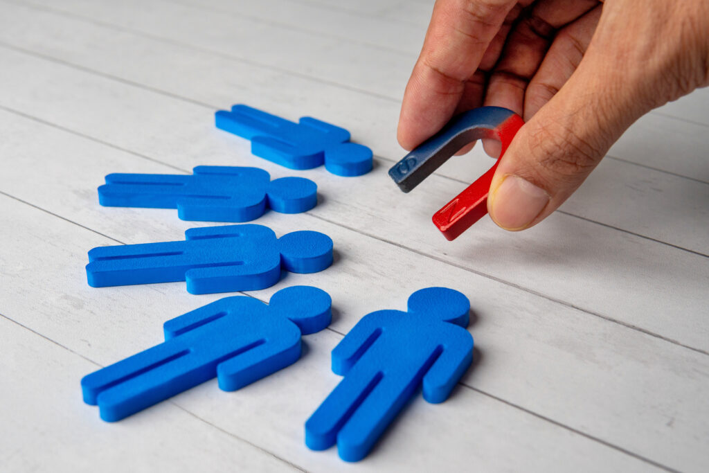 a hand with a magnet symbolizing loyalty programs