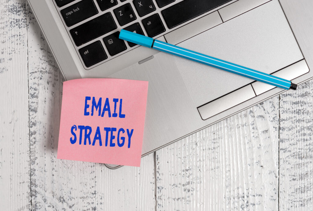 a notebook with a marker and a note saying "email strategy"