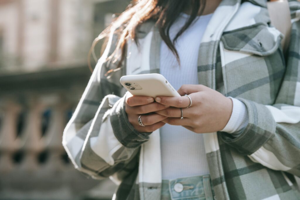 A woman holding a phone. Create amazing push notification campaigns with CDP & CRM CareCloud.