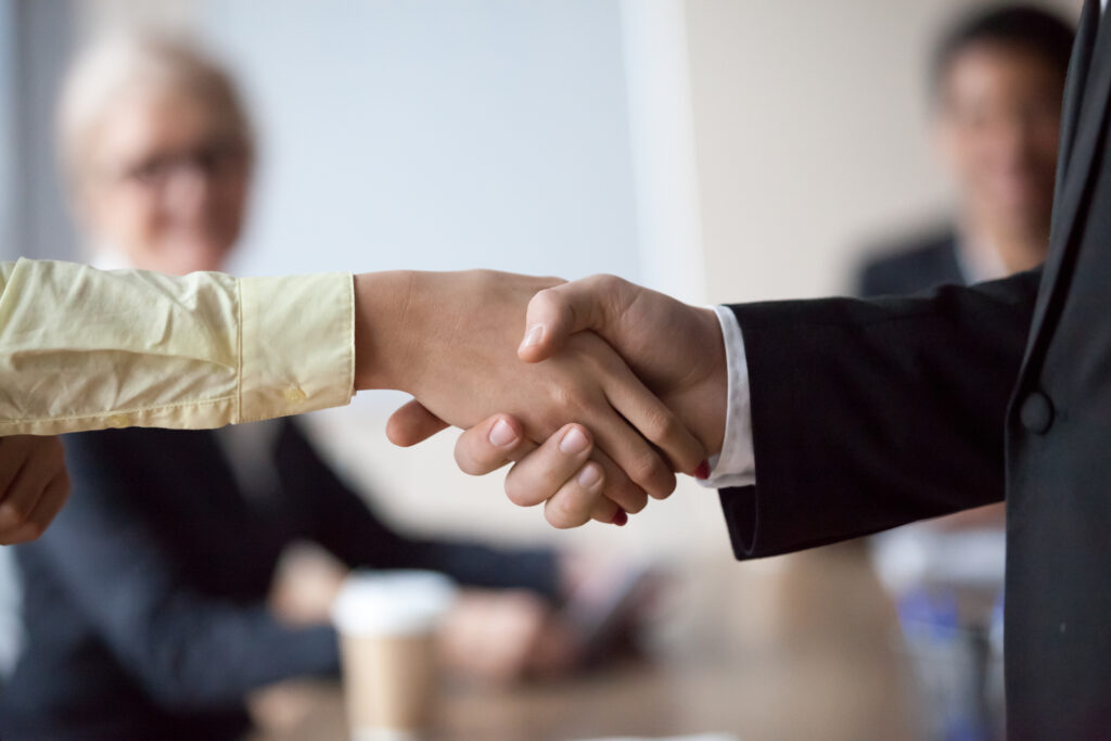two people shaking hands to commemorate customer anniversary